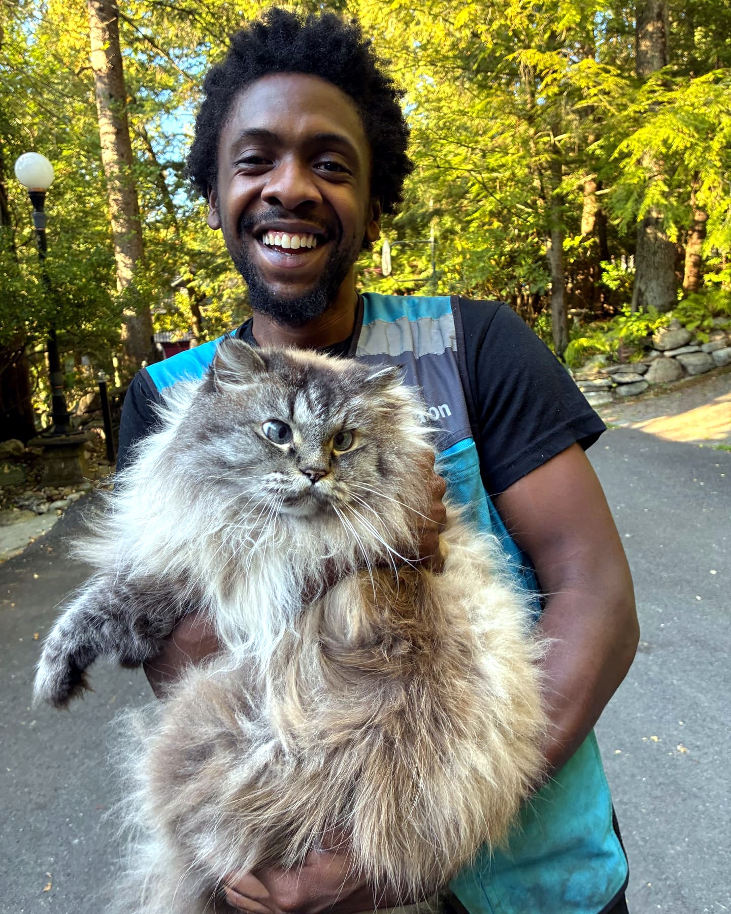 MaxiCat cradled in the arms of a smiling new friend
